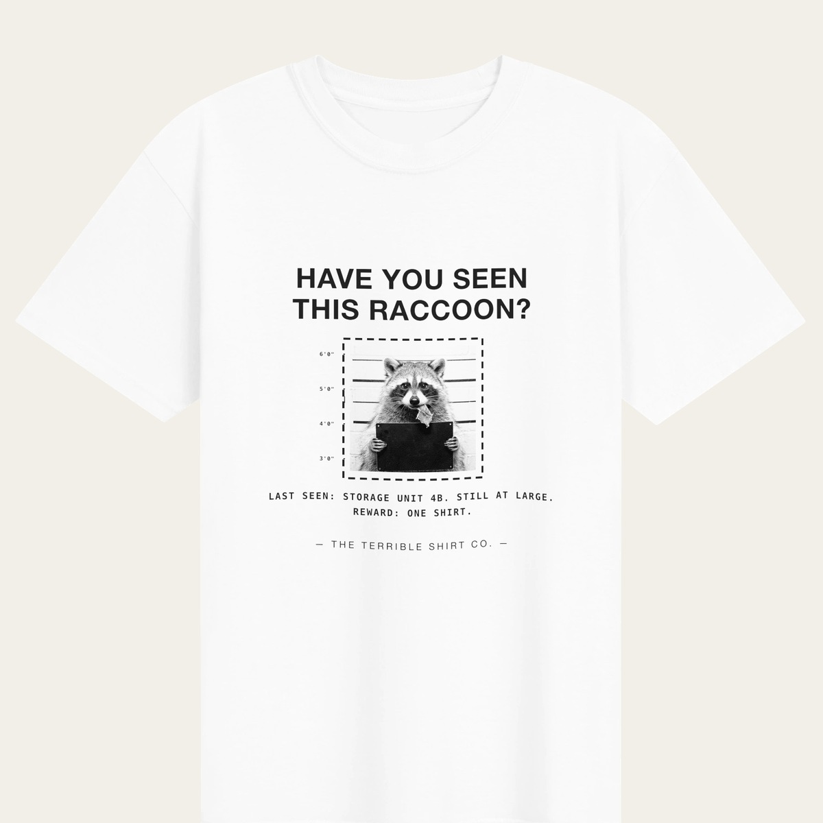 A white heavyweight tee reading HAVE YOU SEEN THIS RACCOON?
